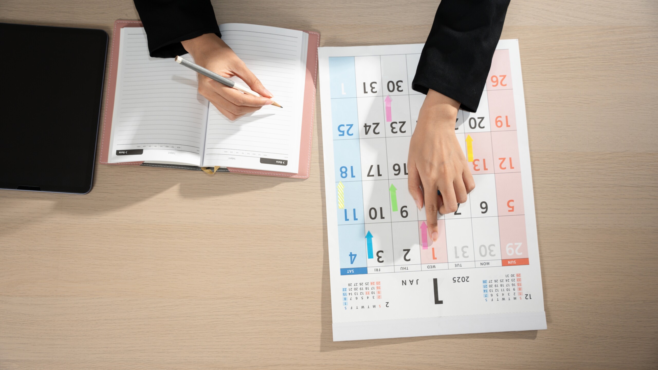 Business professional reviewing calendar and outlining brand marketing strategy.